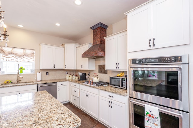 1661 Devonshire Ave, Avon, IN 46123 - kitchen featuring stainless steel appliances, a sink, decorative backsplash, white cabinetry, and custom exhaust hood