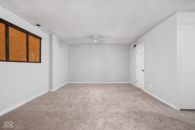 2263 Rome Dr, Indianapolis, IN 46228 - carpeted spare room with a ceiling fan, baseboards, and a textured ceiling