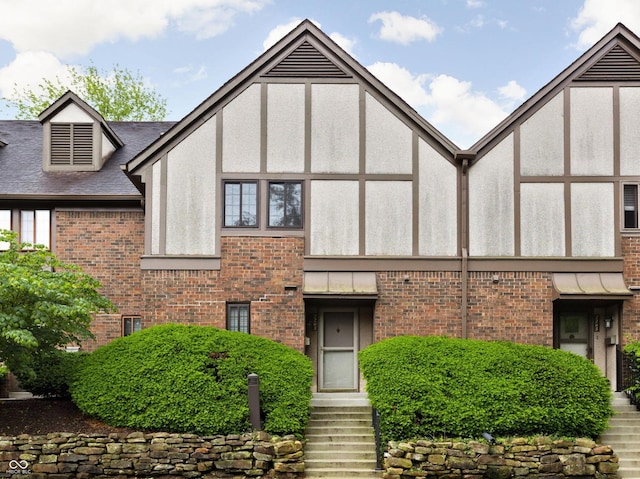 2263 Rome Dr, Indianapolis, IN 46228 - view of front of property featuring brick siding, stucco siding, and roof with shingles
