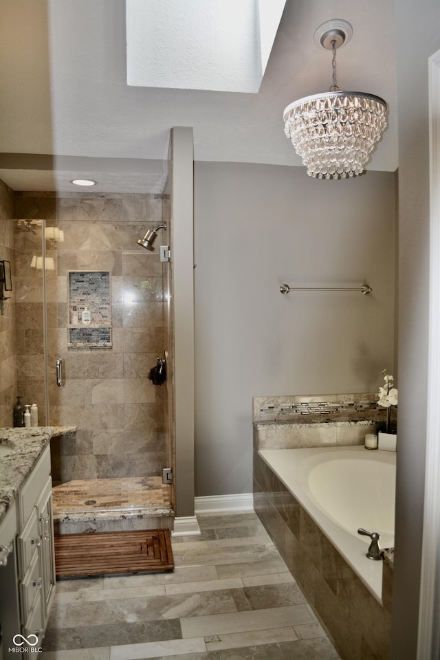 6862 Riverside Way, Fishers, IN 46038 - full bath with a garden tub, a shower stall, vanity, a chandelier, and baseboards