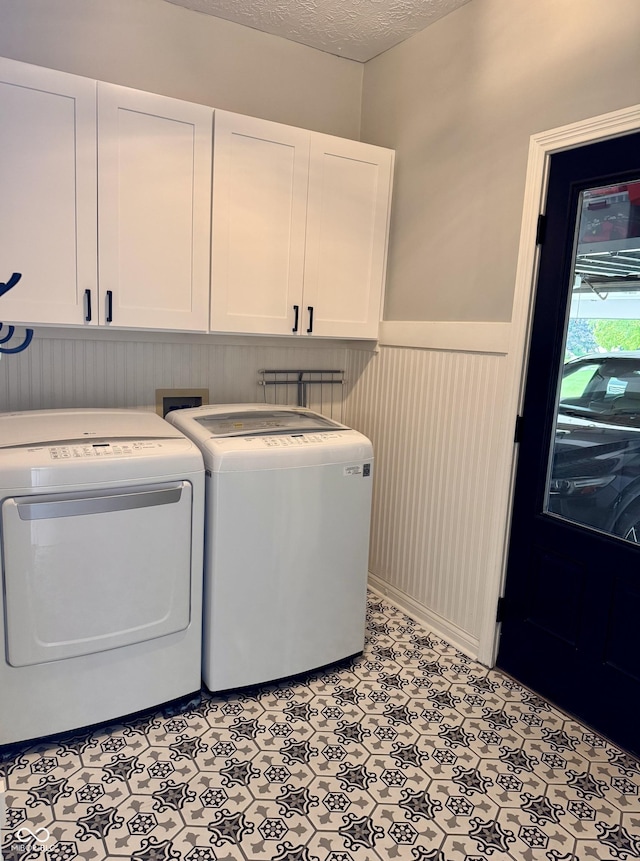 6862 Riverside Way, Fishers, IN 46038 - washroom featuring cabinet space, washer and dryer, wainscoting, a textured ceiling, and light floors