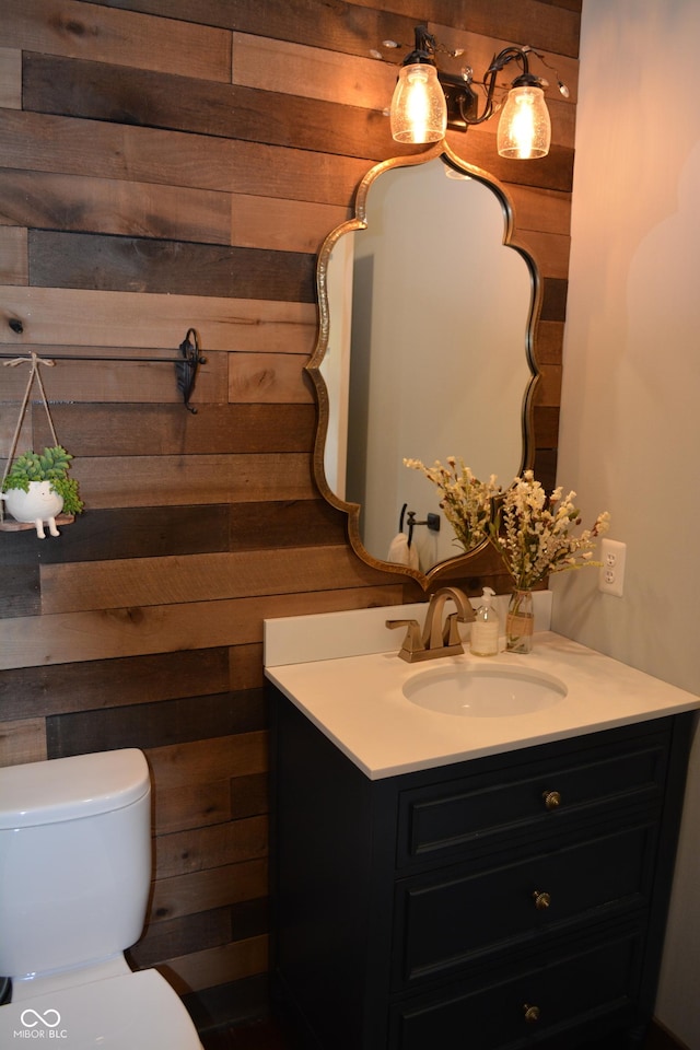 6862 Riverside Way, Fishers, IN 46038 - half bathroom featuring vanity, wood walls, and toilet