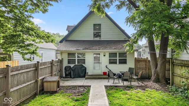 938 N Tuxedo St, Indianapolis, IN 46201 - back of house with a patio area, a fenced backyard, and roof with shingles