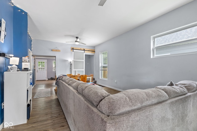938 N Tuxedo St, Indianapolis, IN 46201 - living room featuring a barn door, healthy amount of natural light, ceiling fan, and wood finished floors