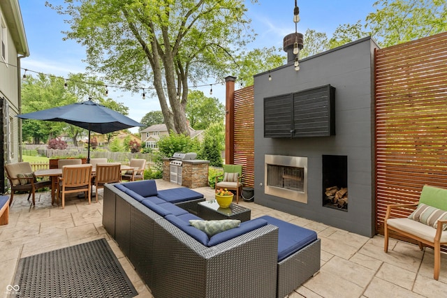 3713 Coventry Way, Carmel, IN 46033 - view of patio / terrace with an outdoor living space with a fireplace, outdoor dining space, and area for grilling