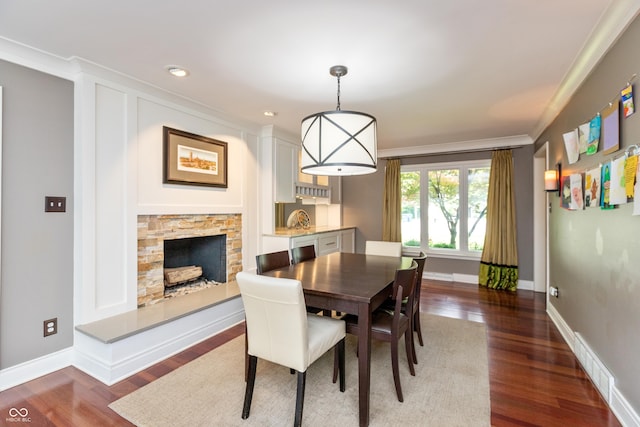 3713 Coventry Way, Carmel, IN 46033 - dining area with ornamental molding, dark wood-style floors, baseboards, a stone fireplace, and recessed lighting
