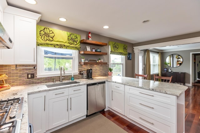 3713 Coventry Way, Carmel, IN 46033 - kitchen with appliances with stainless steel finishes, a peninsula, recessed lighting, white cabinets, and a sink