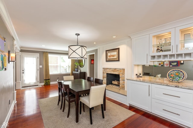 3713 Coventry Way, Carmel, IN 46033 - dining space with dark wood-style floors, crown molding, baseboards, a fireplace, and recessed lighting