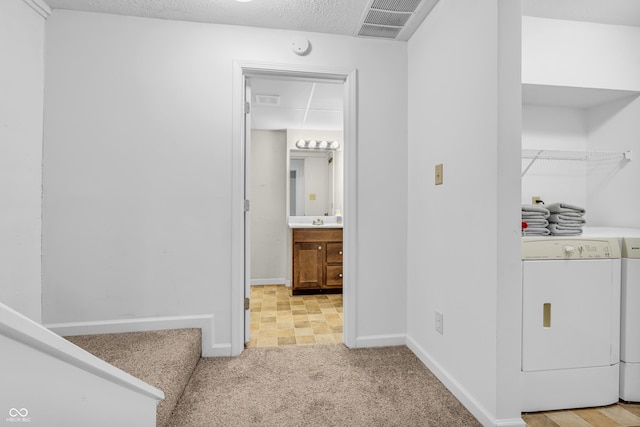 517 E Graham Pl, Bloomington, IN 47401 - hallway featuring washer / dryer, carpet floors, and baseboards