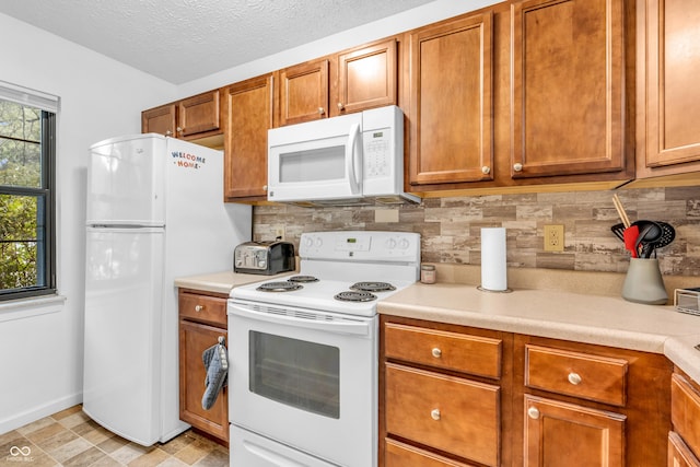 517 E Graham Pl, Bloomington, IN 47401 - kitchen featuring white appliances, decorative backsplash, light countertops, and brown cabinetry