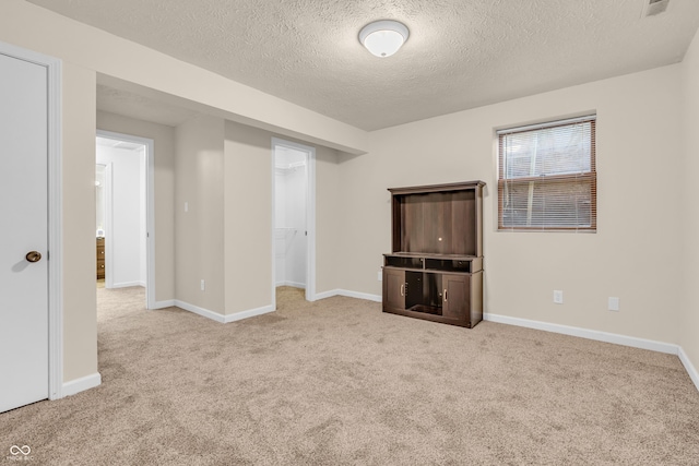 517 E Graham Pl, Bloomington, IN 47401 - spare room featuring a textured ceiling, carpet, and baseboards