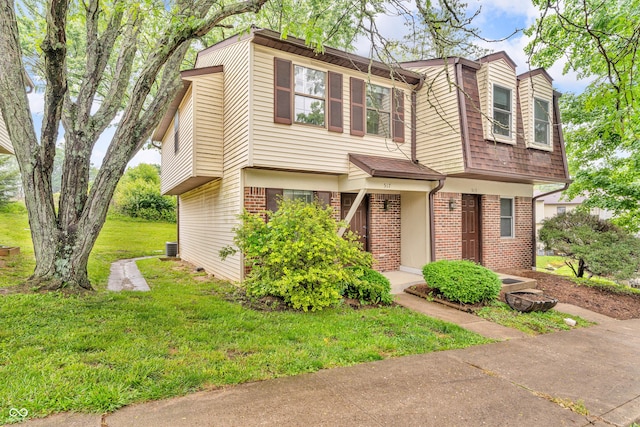 517 E Graham Pl, Bloomington, IN 47401 - view of front facade featuring brick siding, a front lawn, and central AC