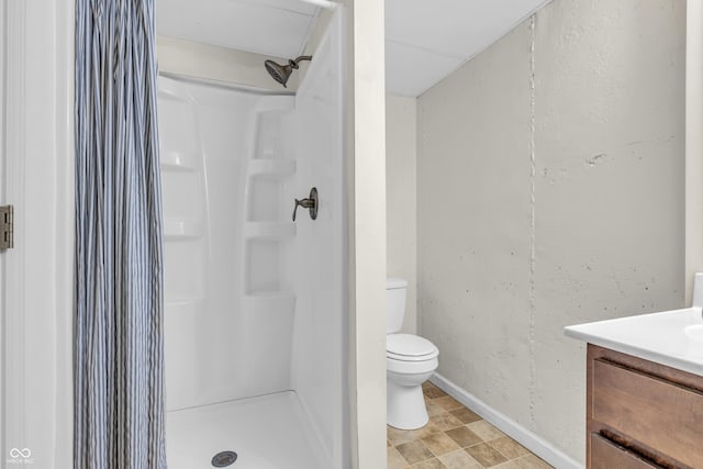 517 E Graham Pl, Bloomington, IN 47401 - bathroom with toilet, vanity, a shower stall, and baseboards