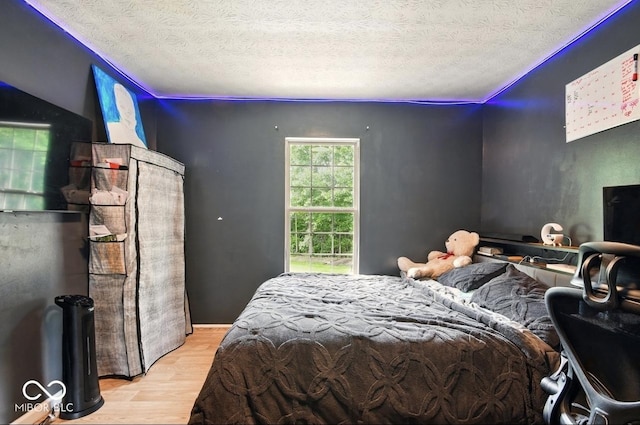 6396 Granny Smith Ln, Avon, IN 46123 - bedroom featuring wood finished floors and a textured ceiling