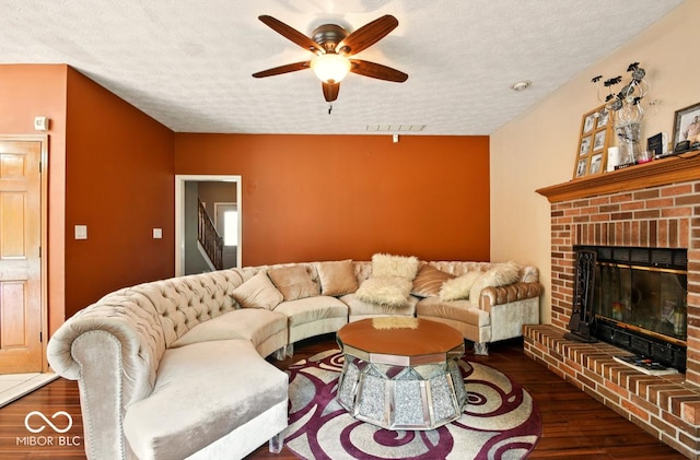 6396 Granny Smith Ln, Avon, IN 46123 - living room with ceiling fan, wood finished floors, a fireplace, and a textured ceiling