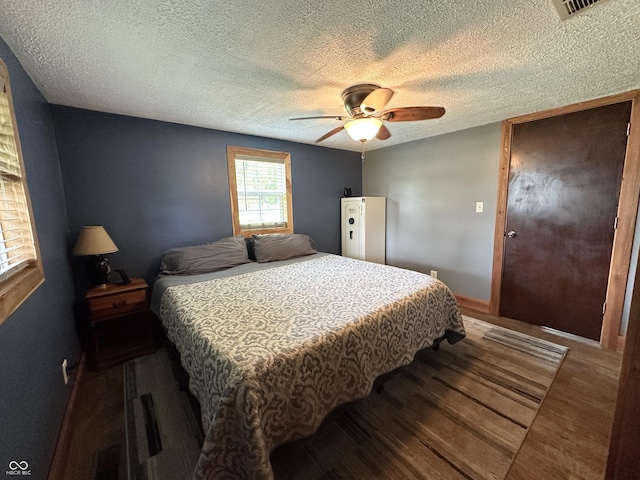 12967 N County Road 825 E, Roachdale, IN 46172 - bedroom with a textured ceiling, a ceiling fan, baseboards, and wood finished floors