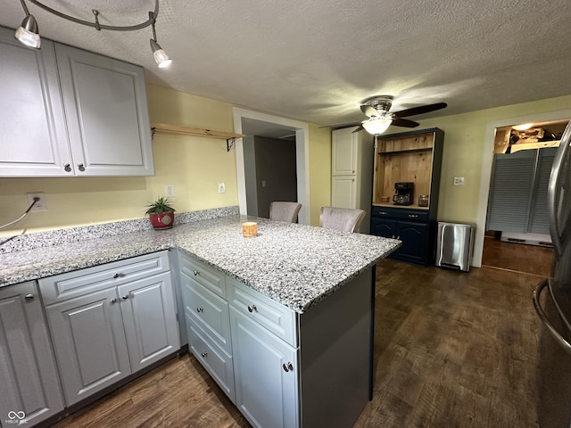 12967 N County Road 825 E, Roachdale, IN 46172 - kitchen featuring ceiling fan, a peninsula, dark wood-style flooring, a textured ceiling, and white cabinets