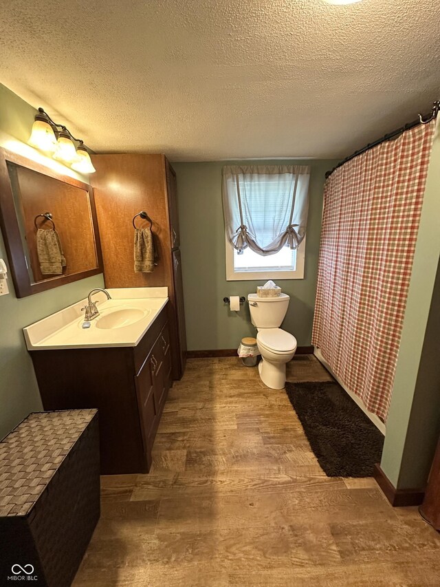 12967 N County Road 825 E, Roachdale, IN 46172 - bathroom with wood finished floors, vanity, a textured ceiling, toilet, and baseboards