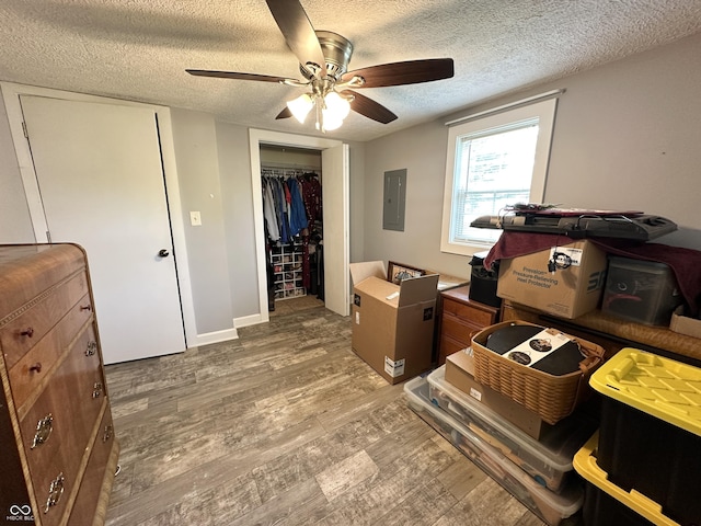 12967 N County Road 825 E, Roachdale, IN 46172 - bedroom with electric panel, light wood finished floors, a textured ceiling, a closet, and ceiling fan