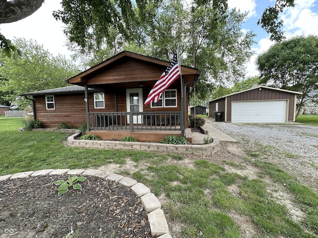 12967 N County Road 825 E, Roachdale, IN 46172 - view of front facade with a porch, a garage, an outdoor structure, and a front yard