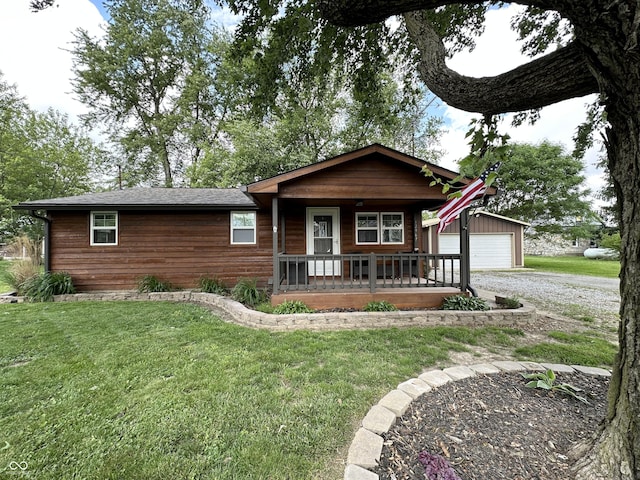 12967 N County Road 825 E, Roachdale, IN 46172 - view of front of home featuring a porch, a front lawn, an outbuilding, and a garage