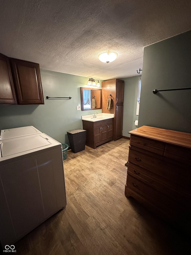 12967 N County Road 825 E, Roachdale, IN 46172 - bathroom with wood finished floors, independent washer and dryer, vanity, and a textured ceiling