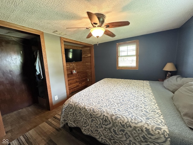 12967 N County Road 825 E, Roachdale, IN 46172 - bedroom with a textured ceiling, a closet, dark wood finished floors, and a ceiling fan