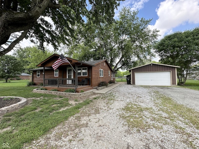 12967 N County Road 825 E, Roachdale, IN 46172 - view of front facade with a porch, an outdoor structure, a front lawn, and a garage