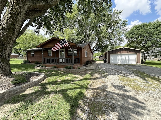 12967 N County Road 825 E, Roachdale, IN 46172 - view of front facade with a detached garage, an outbuilding, a porch, and a front lawn