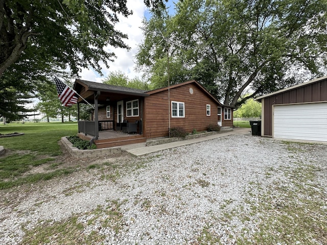 12967 N County Road 825 E, Roachdale, IN 46172 - view of property exterior featuring covered porch, a lawn, and gravel driveway
