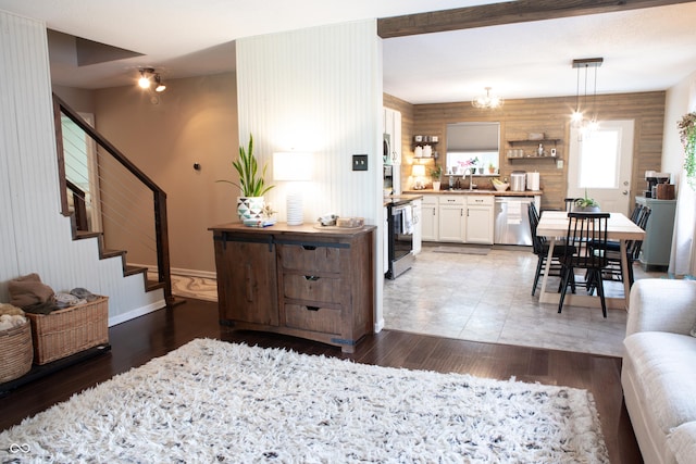 2210 Bridlewood Dr, Franklin, IN 46131 - living room featuring wood finished floors, stairway, and a chandelier