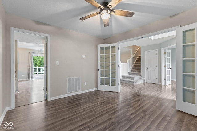 5852 Long Ridge Pl, Indianapolis, IN 46221 - unfurnished room featuring french doors, dark wood-style flooring, baseboards, a ceiling fan, and stairway