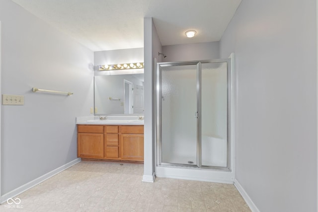 5852 Long Ridge Pl, Indianapolis, IN 46221 - bathroom featuring a stall shower, double vanity, baseboards, and tile patterned flooring