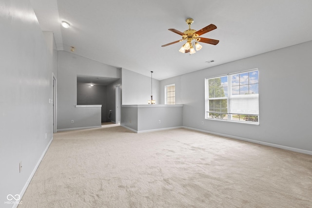 5852 Long Ridge Pl, Indianapolis, IN 46221 - unfurnished living room featuring carpet, vaulted ceiling, baseboards, and a ceiling fan