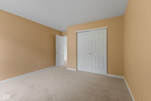 5852 Long Ridge Pl, Indianapolis, IN 46221 - unfurnished bedroom with light colored carpet, baseboards, and a closet
