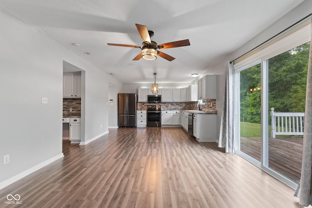 5852 Long Ridge Pl, Indianapolis, IN 46221 - unfurnished living room featuring ceiling fan, light wood-style flooring, baseboards, and a sink