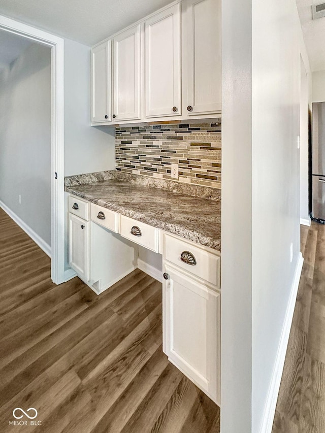 5852 Long Ridge Pl, Indianapolis, IN 46221 - kitchen featuring dark wood-style flooring, white cabinets, tasteful backsplash, baseboards, and light stone counters