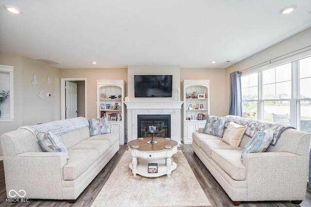 7184 Lillian Pl, Cumberland, IN 46229 - living room featuring wood finished floors, a premium fireplace, recessed lighting, and built in features