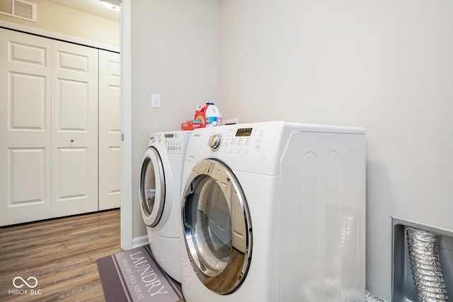 7184 Lillian Pl, Cumberland, IN 46229 - laundry area with washing machine and dryer and wood finished floors