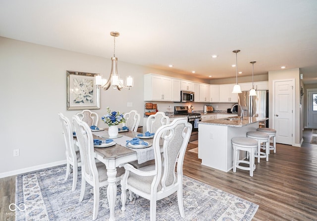 7184 Lillian Pl, Cumberland, IN 46229 - dining space featuring wood finished floors, a chandelier, recessed lighting, and baseboards
