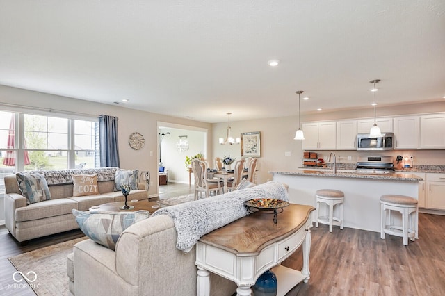 7184 Lillian Pl, Cumberland, IN 46229 - living room with dark wood finished floors, recessed lighting, and a chandelier