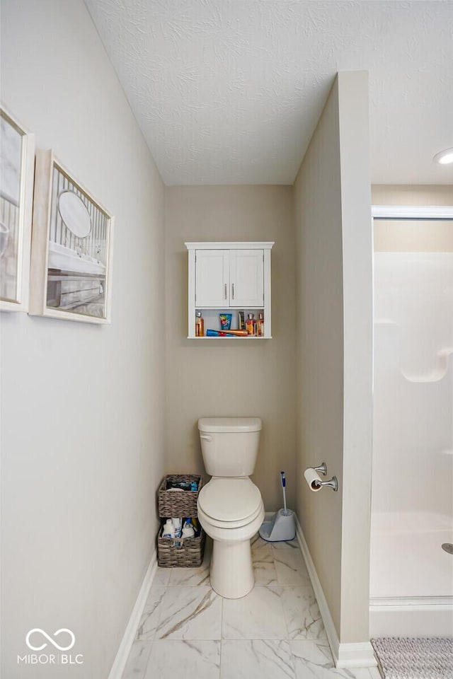 7184 Lillian Pl, Cumberland, IN 46229 - bathroom with toilet, marble finish floors, a stall shower, baseboards, and a textured ceiling