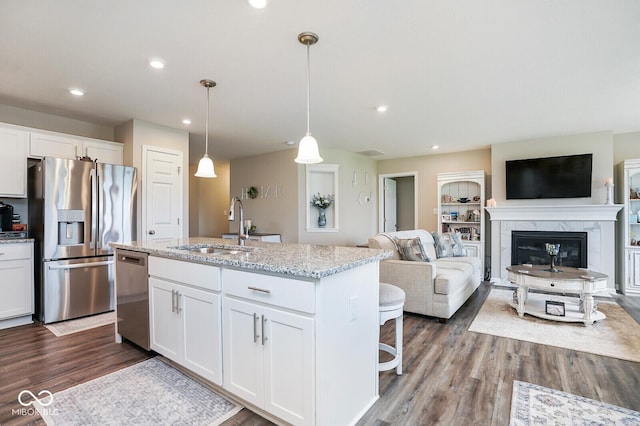 7184 Lillian Pl, Cumberland, IN 46229 - kitchen featuring stainless steel appliances, a sink, dark wood-style floors, white cabinets, and an island with sink