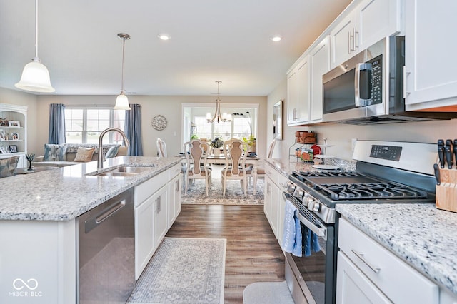7184 Lillian Pl, Cumberland, IN 46229 - kitchen featuring stainless steel appliances, a sink, healthy amount of natural light, white cabinets, and recessed lighting