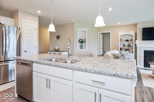 7184 Lillian Pl, Cumberland, IN 46229 - kitchen featuring appliances with stainless steel finishes, a sink, dark wood finished floors, white cabinetry, and open floor plan