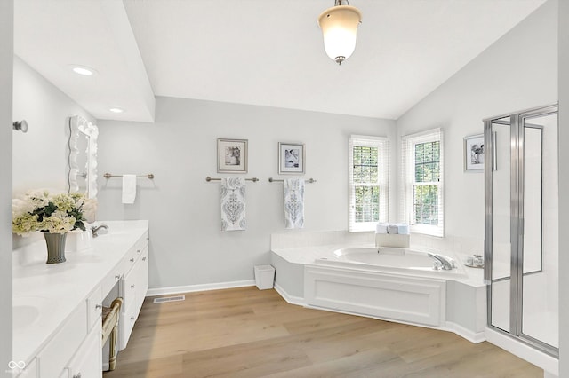 10965 Fairway Ridge Ln, Fishers, IN 46037 - bathroom with a bath, wood finished floors, vaulted ceiling, double vanity, and a stall shower