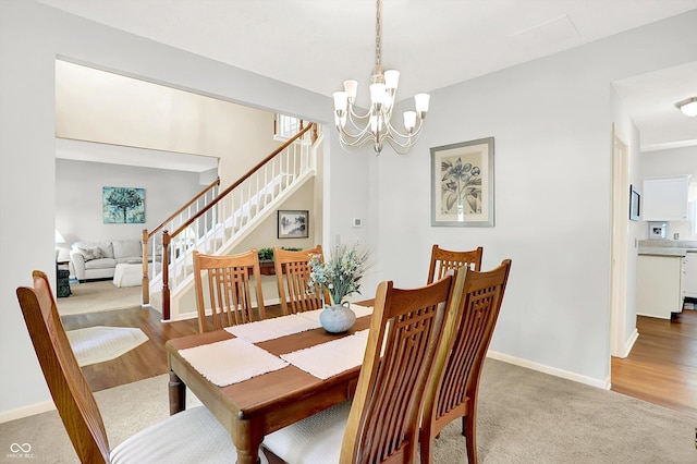 10965 Fairway Ridge Ln, Fishers, IN 46037 - carpeted dining space with a chandelier, stairway, baseboards, and wood finished floors