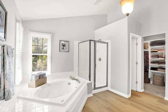 10965 Fairway Ridge Ln, Fishers, IN 46037 - full bath featuring a garden tub, a stall shower, wood finished floors, a spacious closet, and high vaulted ceiling