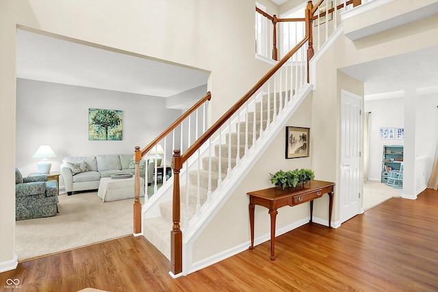 10965 Fairway Ridge Ln, Fishers, IN 46037 - stairway featuring wood finished floors, baseboards, and a towering ceiling