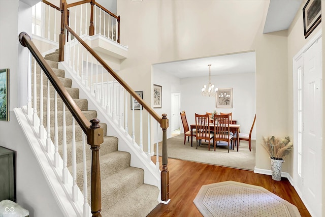 10965 Fairway Ridge Ln, Fishers, IN 46037 - foyer entrance featuring stairs, wood finished floors, a chandelier, and baseboards